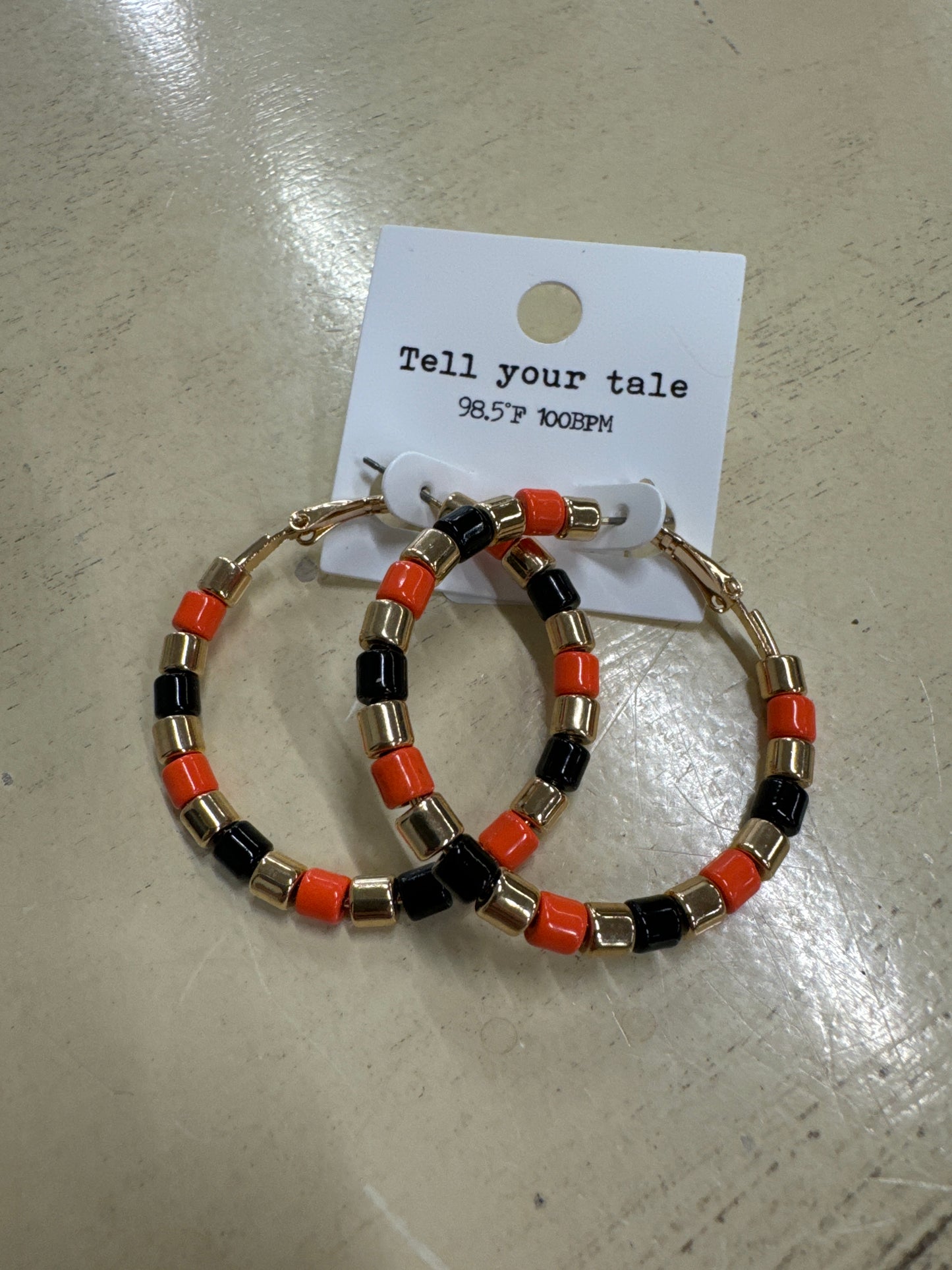 TELL YOUR TALE-ORANGE/BLK/GOLD HOOP