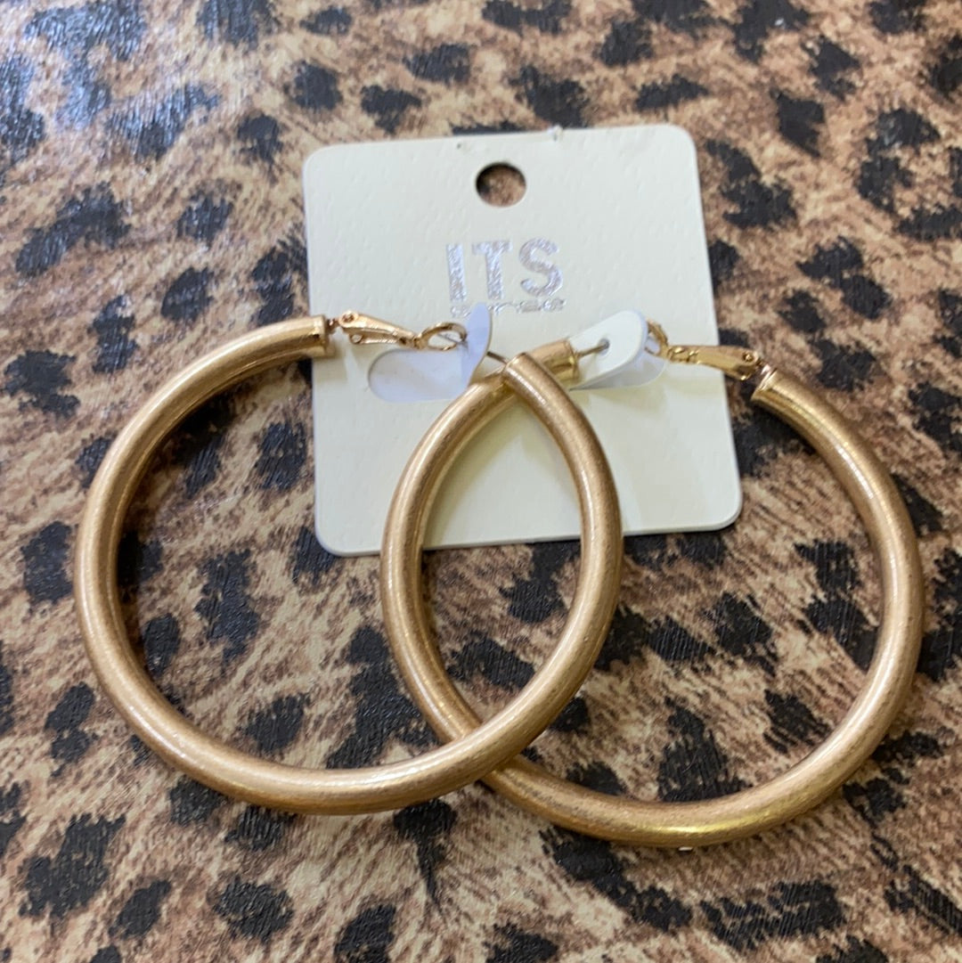 ITS LARGE GOLD HOOPS